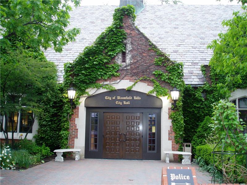 a house with bushes in front of a building a house with bushes in front of a building