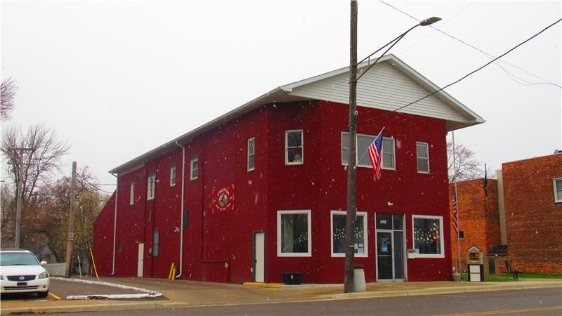 a building that has a sign on the side of a road