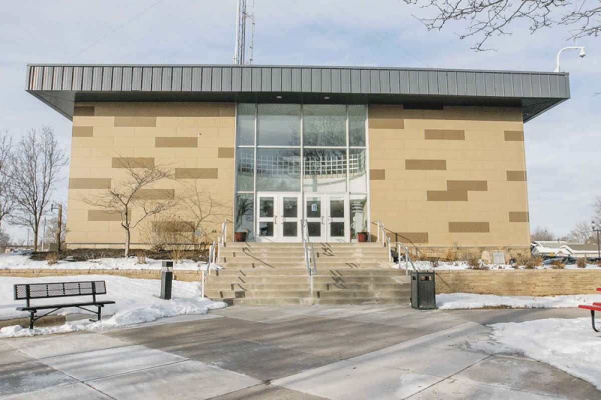 an empty park bench next to a building