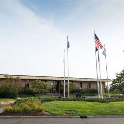 a tower that has a sign on the side of a road