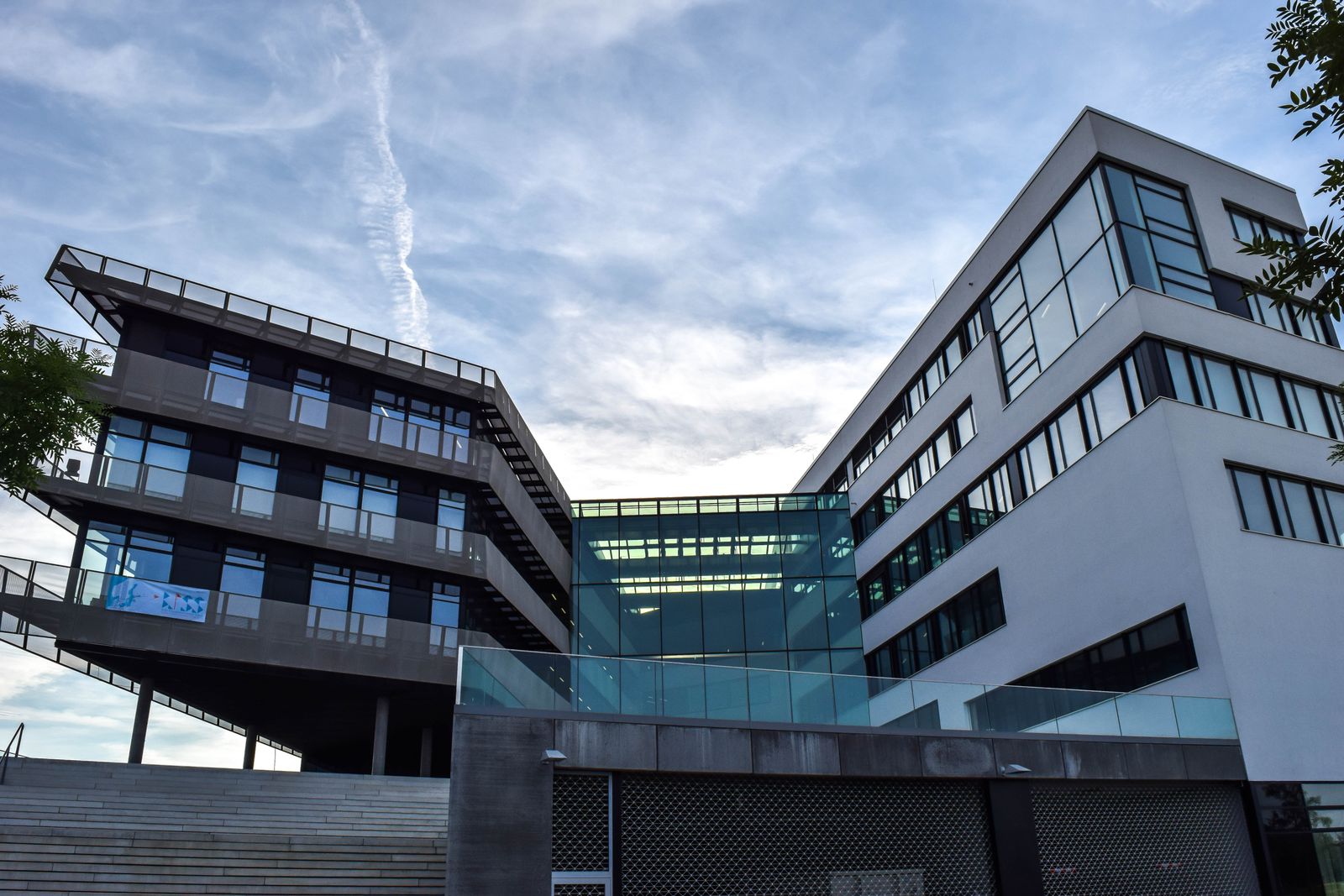 a large building Modern office building with cantilevered upper floors and a glass connector